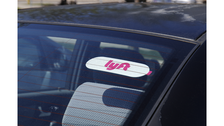 Car for hire with a Lyft sticker. Lyft and Uber have replaced many Taxi cabs for transportation with a smart phone app I