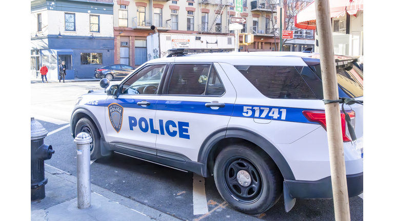 NYPD patrol car at the side of the road on Christopher Street