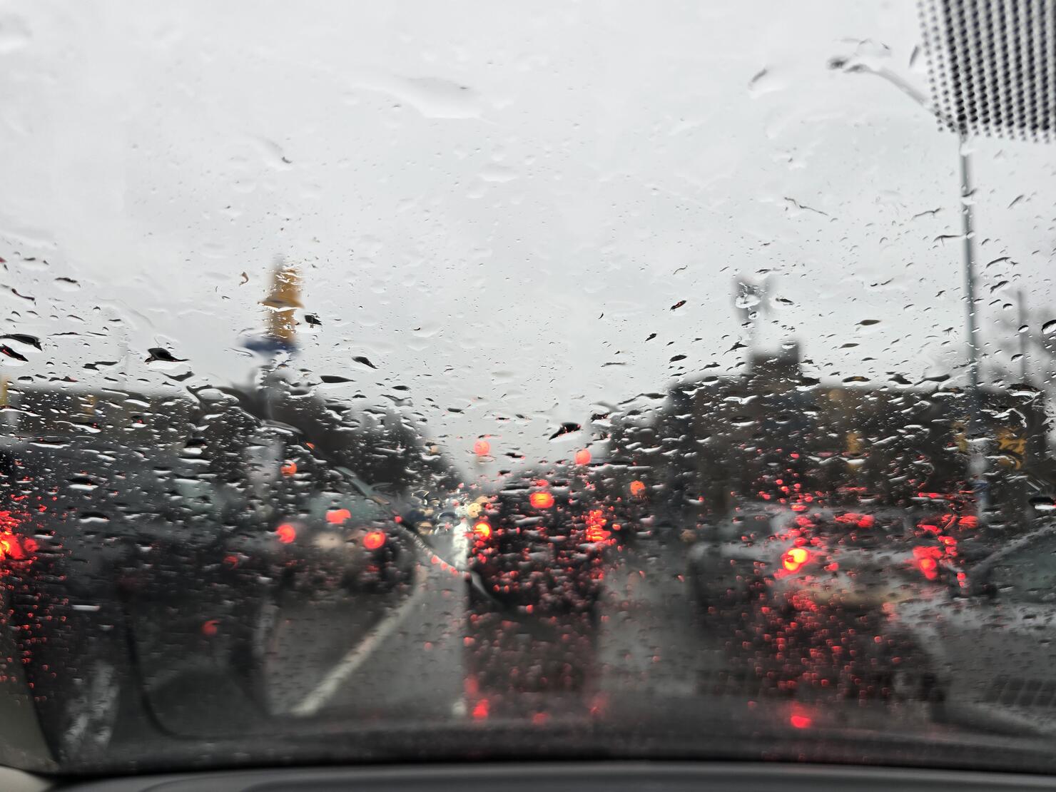 Rainy Day Traffic View Through a Car Windshield