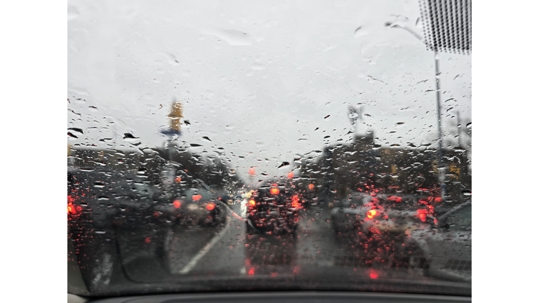 Rainy Day Traffic View Through a Car Windshield