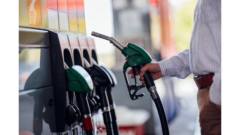 Close-Up of Man Refueling Vehicle at Gas Station Pump