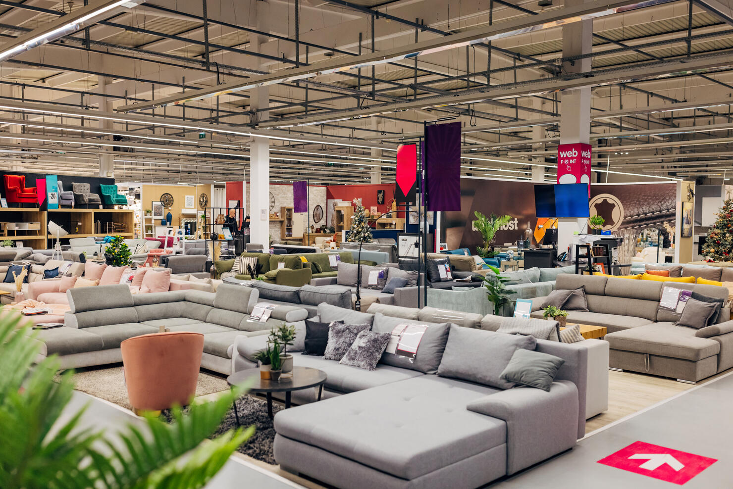 Furniture store with many sofas, armchairs and other furniture in different colors and materials