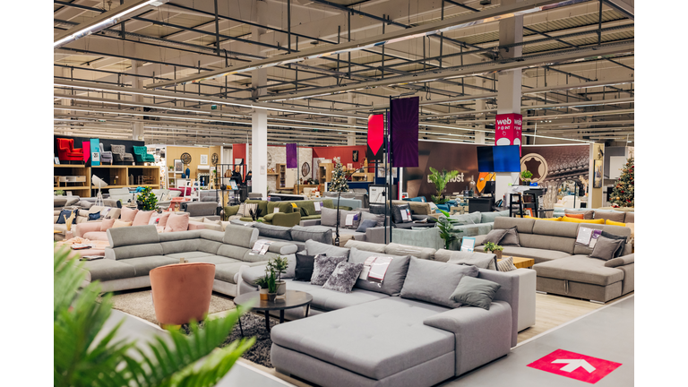 Furniture store with many sofas, armchairs and other furniture in different colors and materials