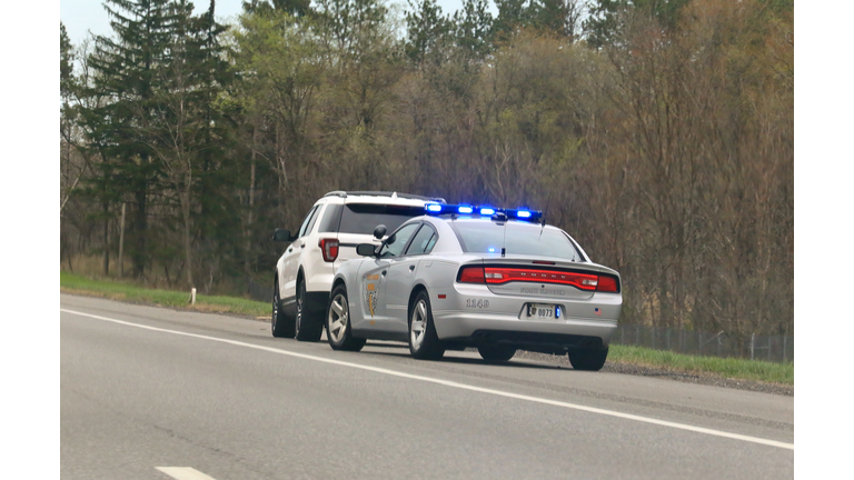 Police vehicle stop a speeding motorist on a rural highway