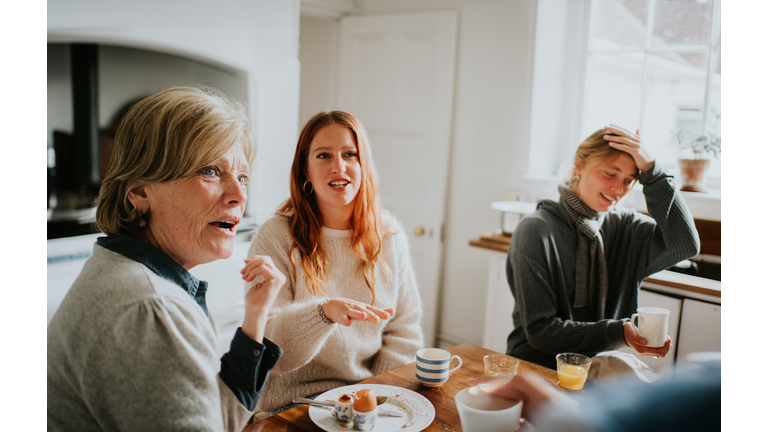 A family have a heated debate around a kitchen table