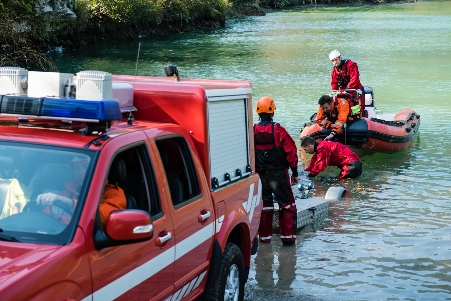 Dam construction on the river - rescue operation with a boat, oil spill