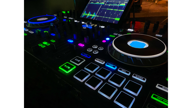 dj mixtable with colors in night club