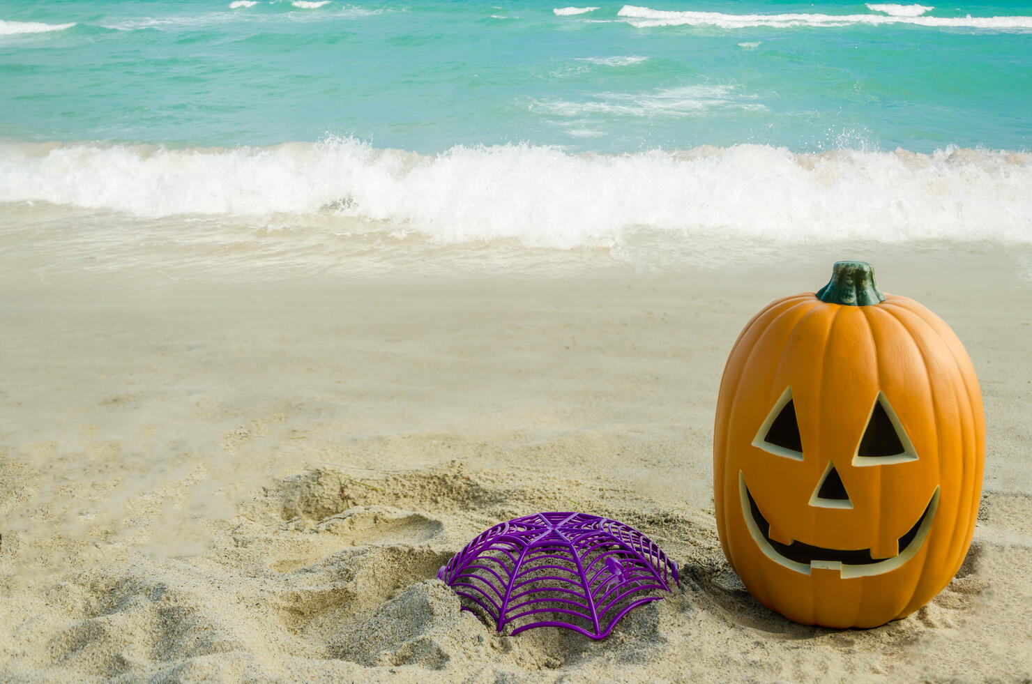 Halloween pumpkin background on the beach