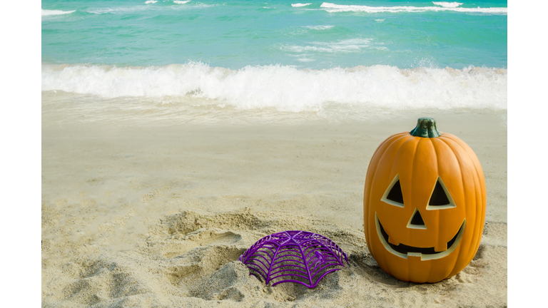 Halloween pumpkin background on the beach