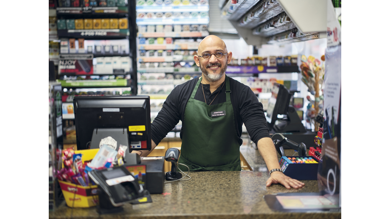 Small Business Owner at Work in His Small Convenience Store