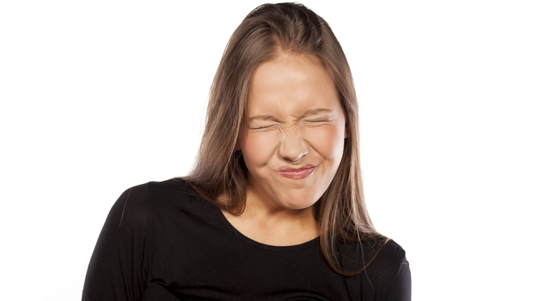 Young woman with sour gesture