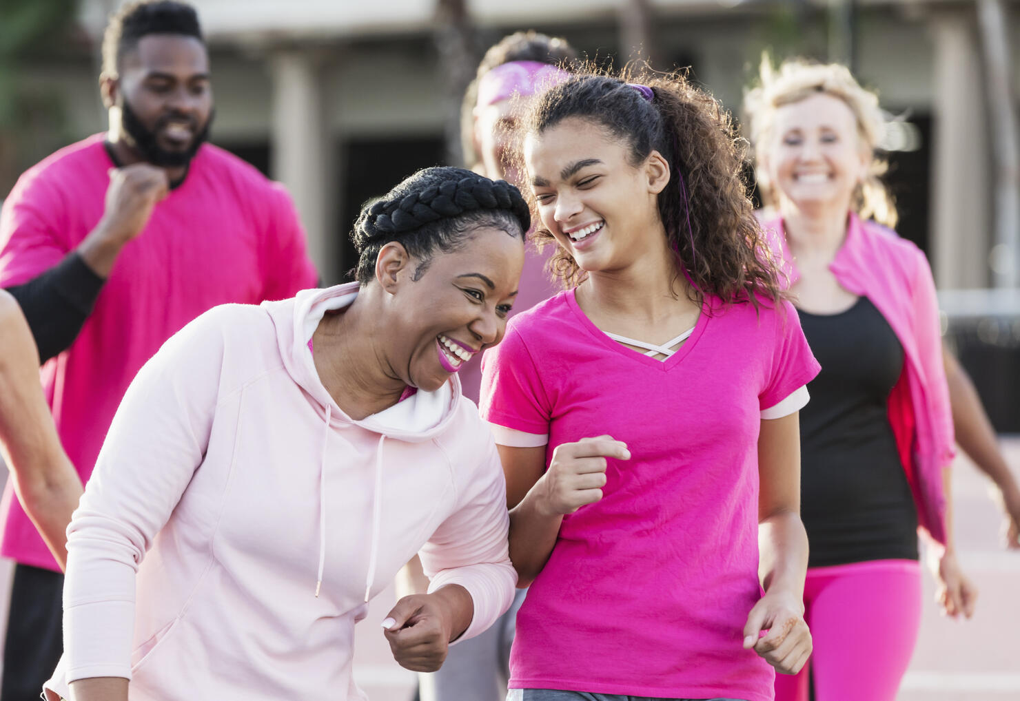 Woman, teenage girl, with group at breast cancer walk