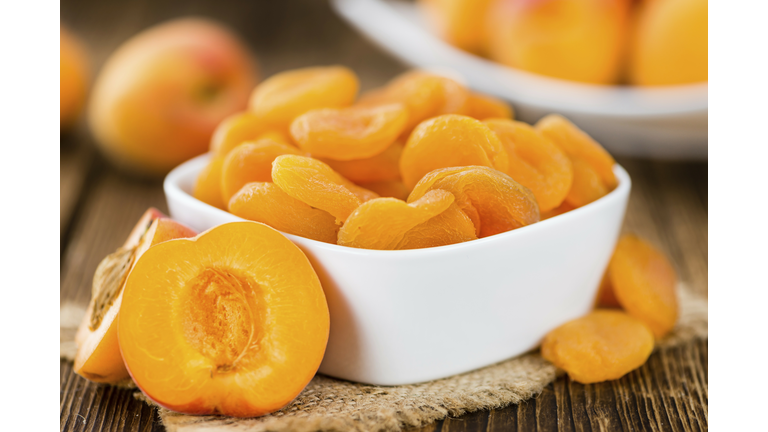 Dried Food (Apricots) on an old wooden table as detailed close-up shot (selective focus)