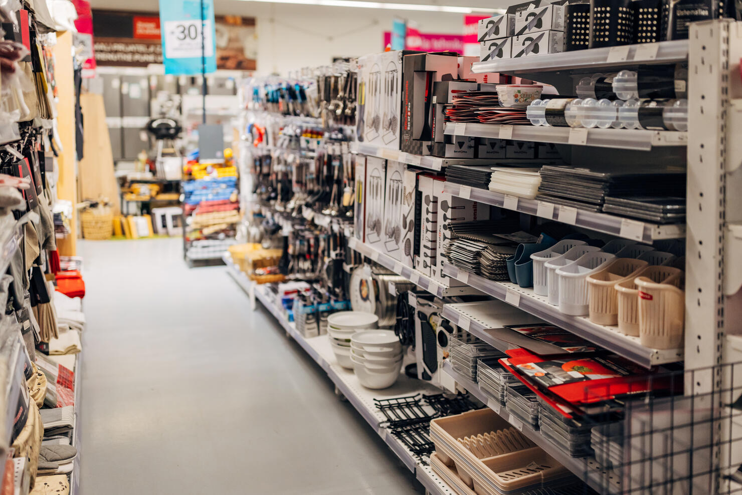 The shelves in the department store are full of plastic accessories for the kitchen