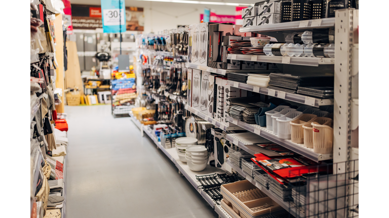 The shelves in the department store are full of plastic accessories for the kitchen