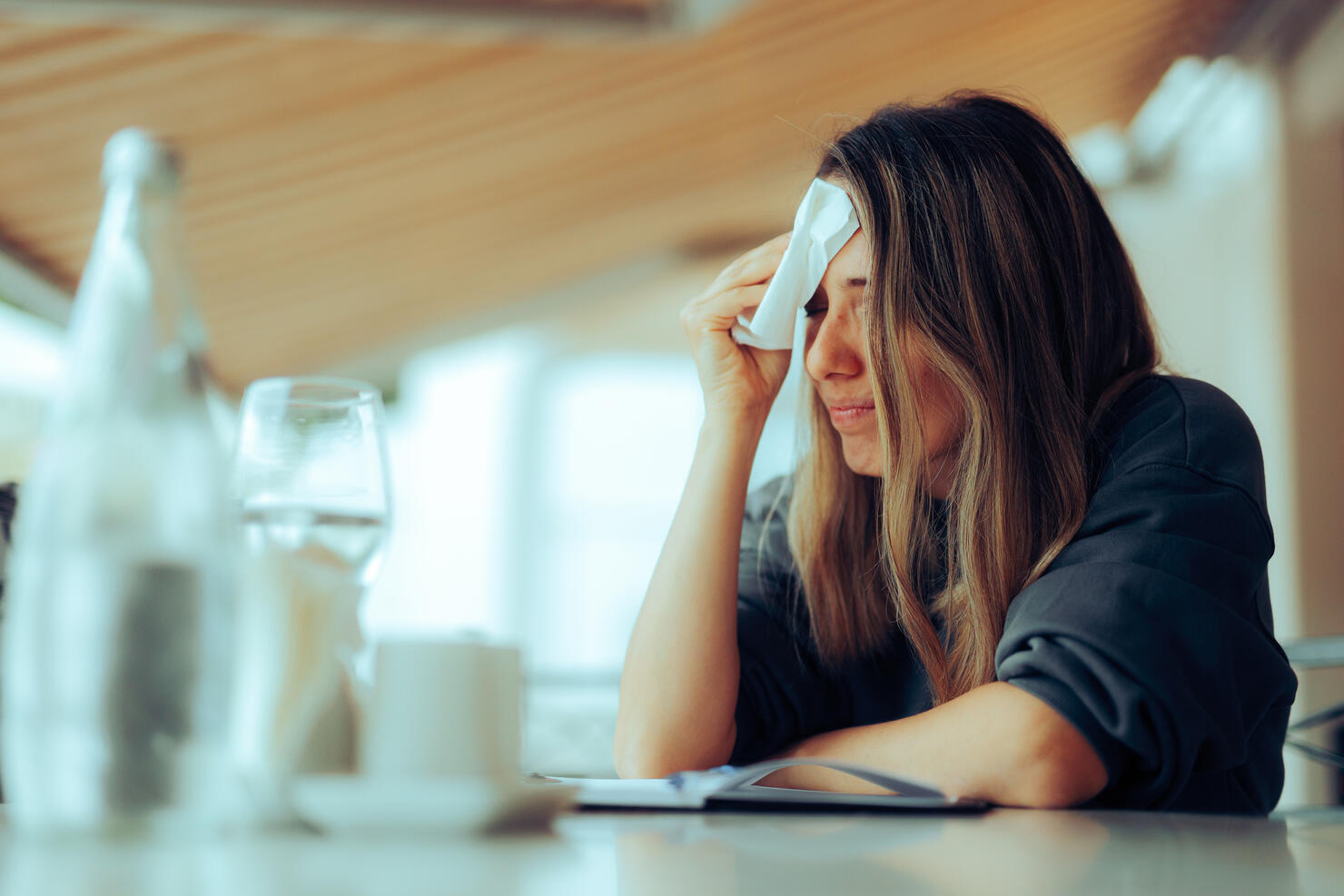 Woman Wiping Sweaty Forehead Using a Napkin