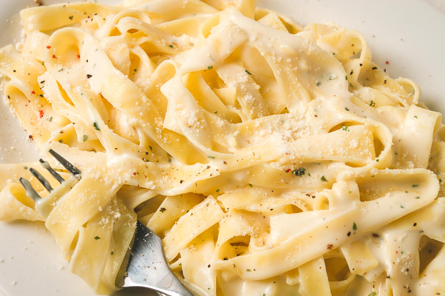 Fettuccine, tagliatelle, in creamy garlic sauce, Italian traditional cuisine, pasta carbonaro,