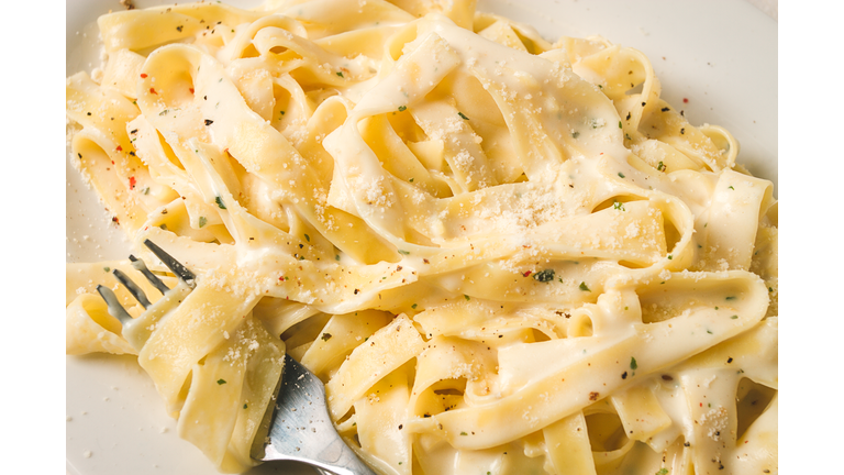 Fettuccine, tagliatelle, in creamy garlic sauce, Italian traditional cuisine, pasta carbonaro,
