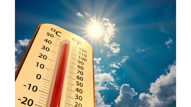 low angle view Thermometer on blue sky with sun shining