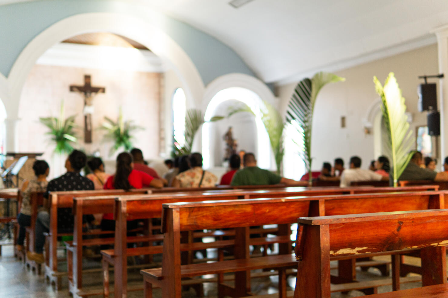 Background of uknown people blurred at the catholic church.