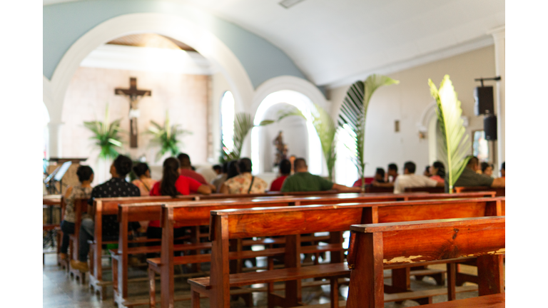 Background of uknown people blurred at the catholic church.