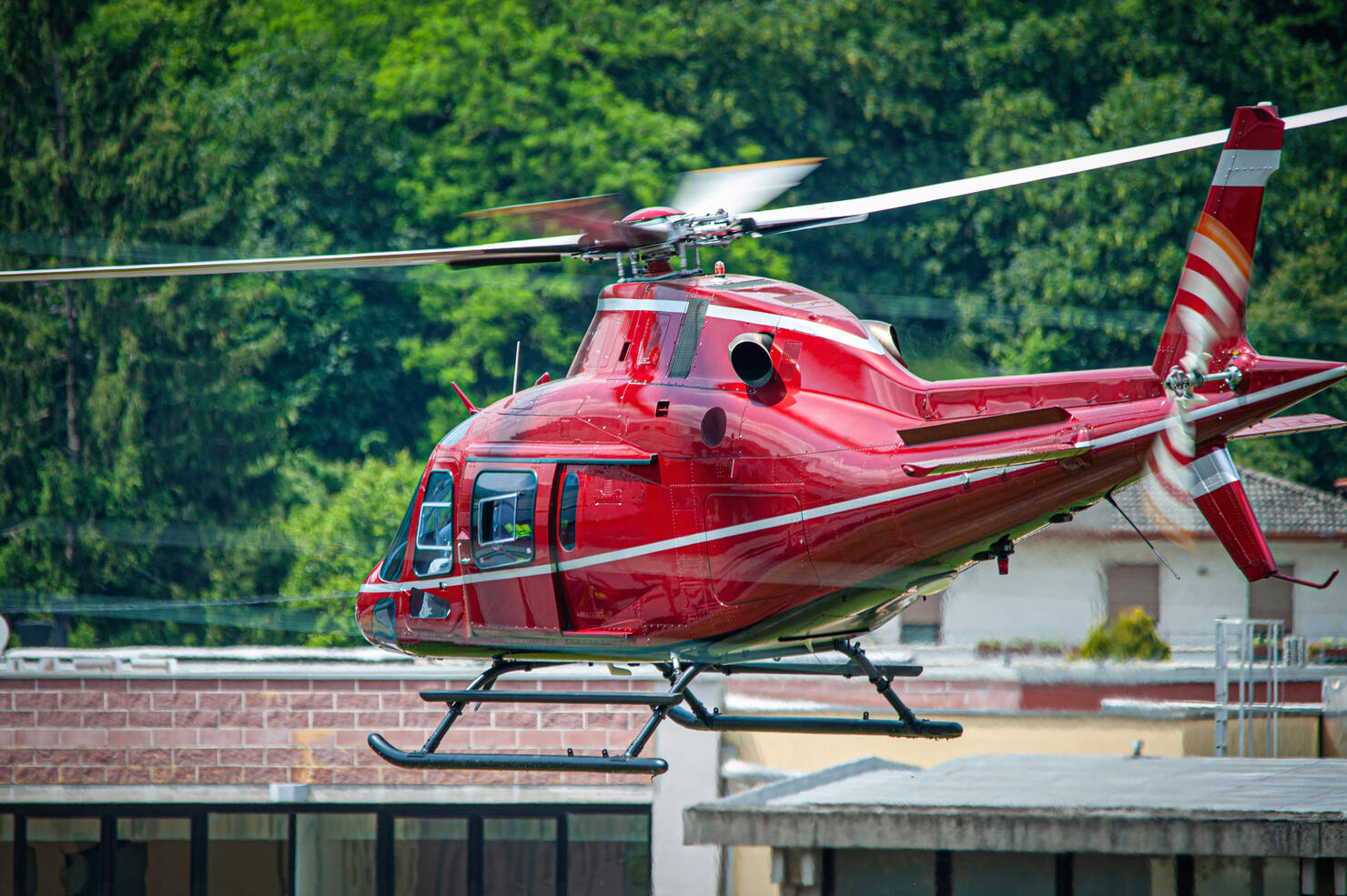 red helicopter in flight