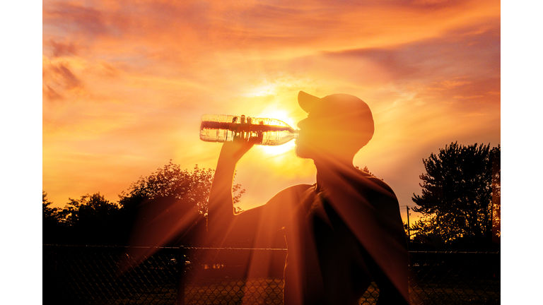 Man drinking water during heat wave