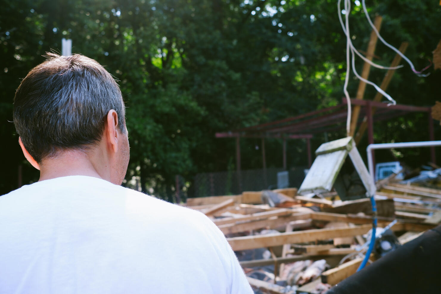 Man Views Rubble From Partial Home Demolition