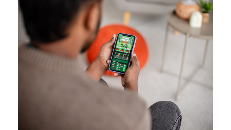 Man checking sports results on mobile device screen