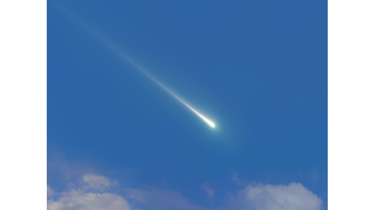 Bright meteor in daylight. Fireball in the blue sky.