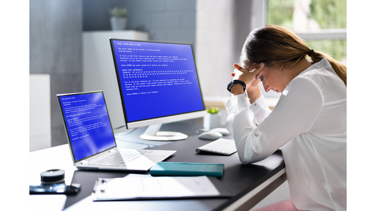Worried Woman At Computer With System Failure Screen