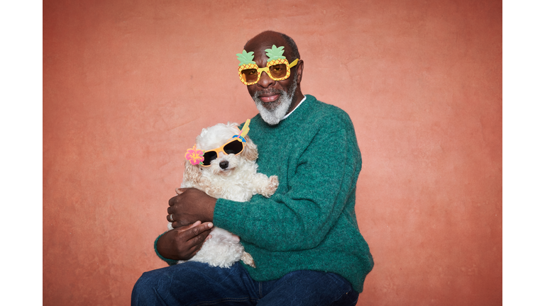 Portrait of a senior man with his pet dog.