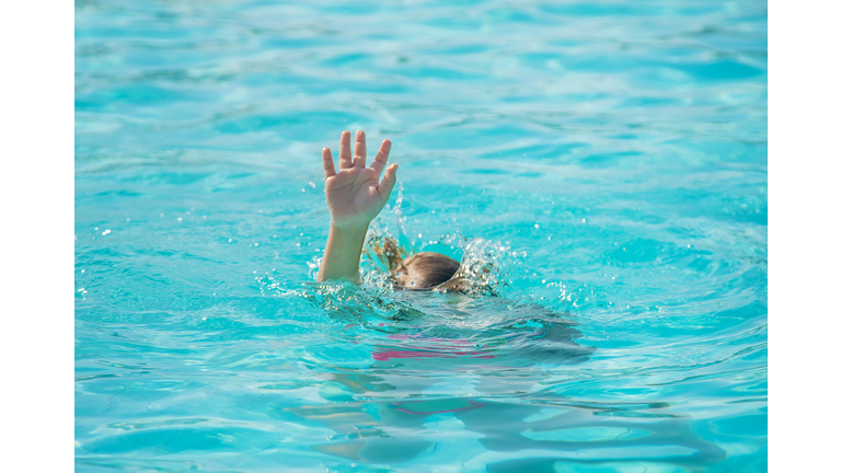 Young Woman Swimming In Pool