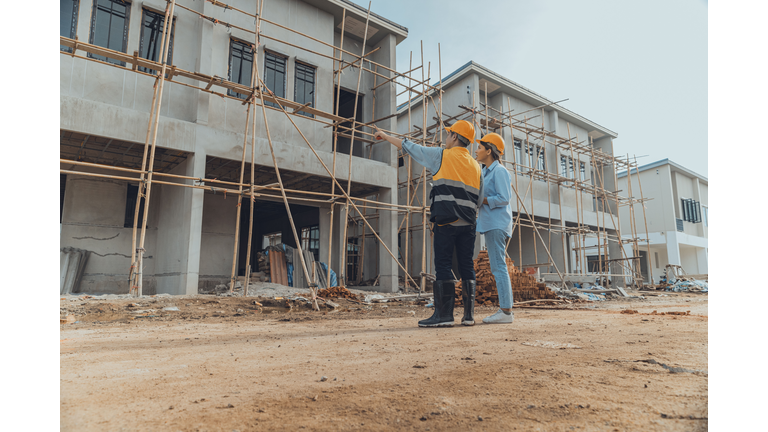 Site manager working with client to inspect site.