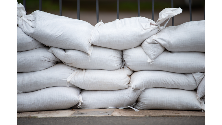 Sandbags for flood defense, river Moselle Trier in Rhineland Palatinate, flooded trees and paths, high water level, climate change