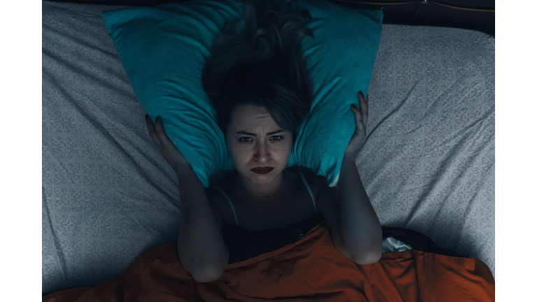 Sad Woman Lying On Bed