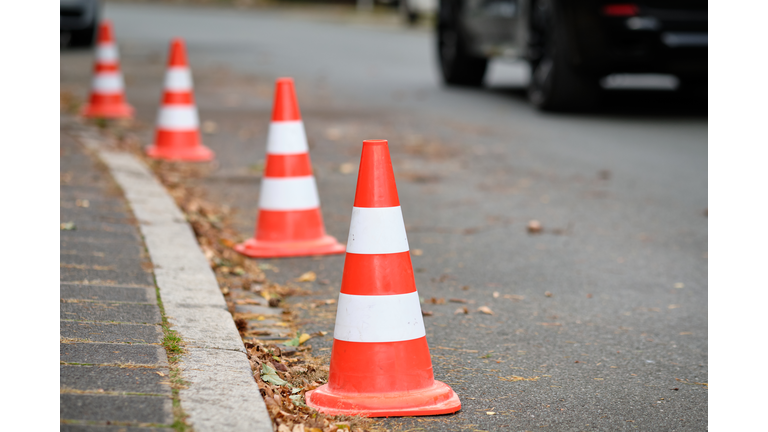 A row of traffic cones standing on a street