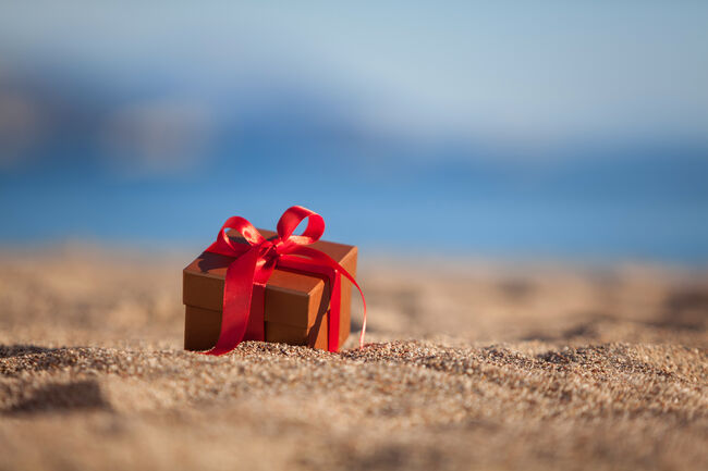 Terracotta color gift box ona beach