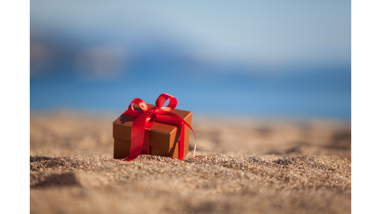 Terracotta color gift box ona beach