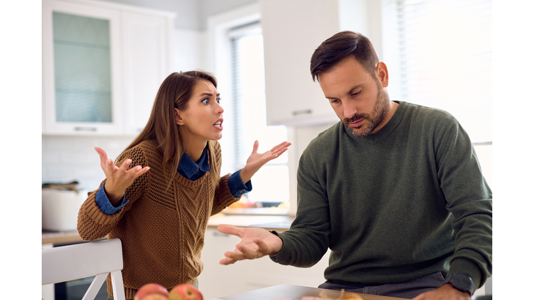 Displeased couple arguing about something at home.