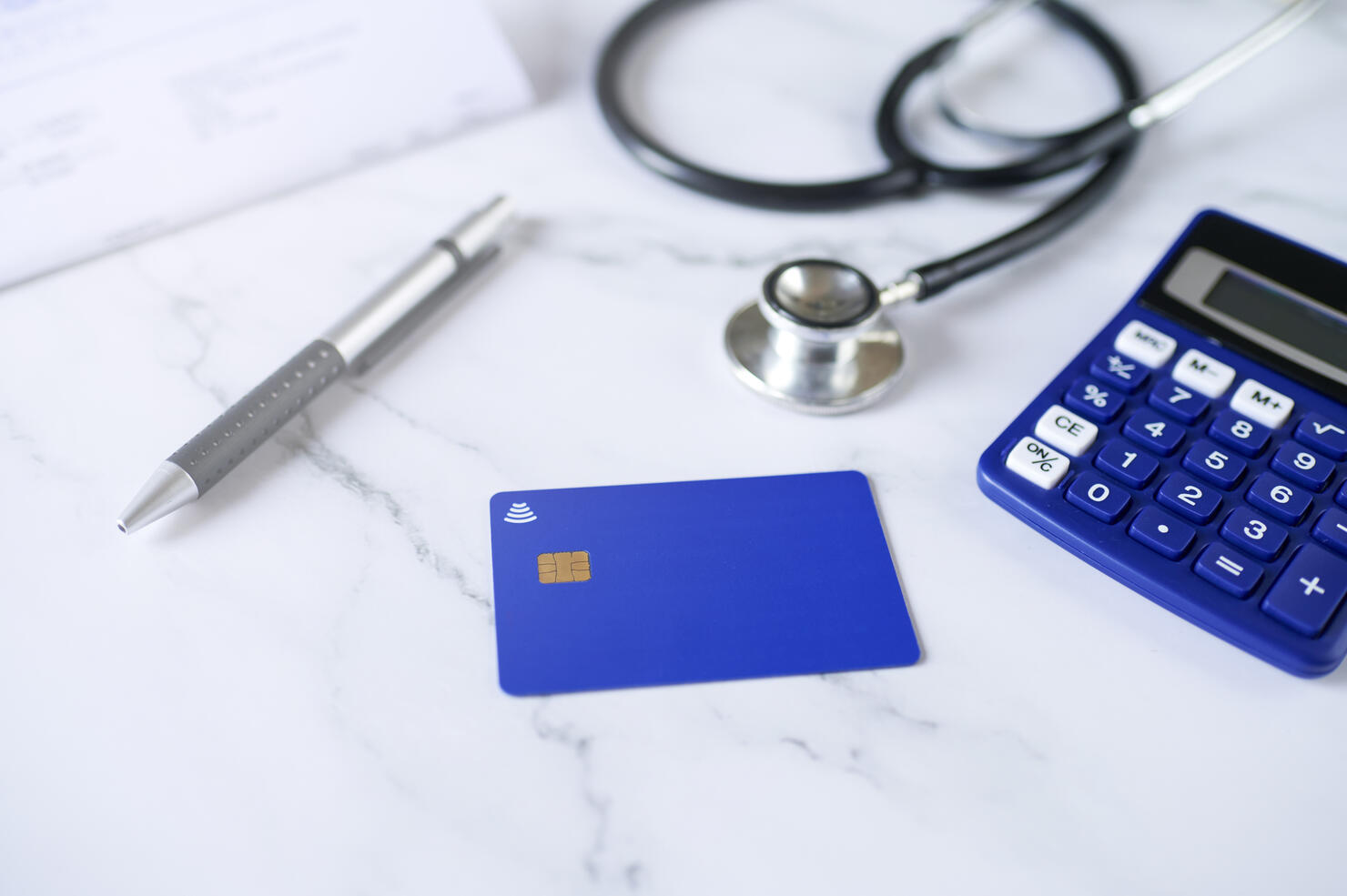 Blue credit card next to stenoscope and calculator