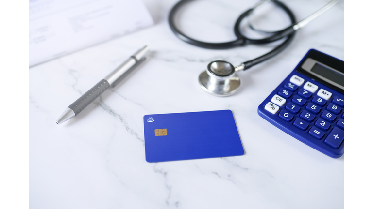 Blue credit card next to stenoscope and calculator
