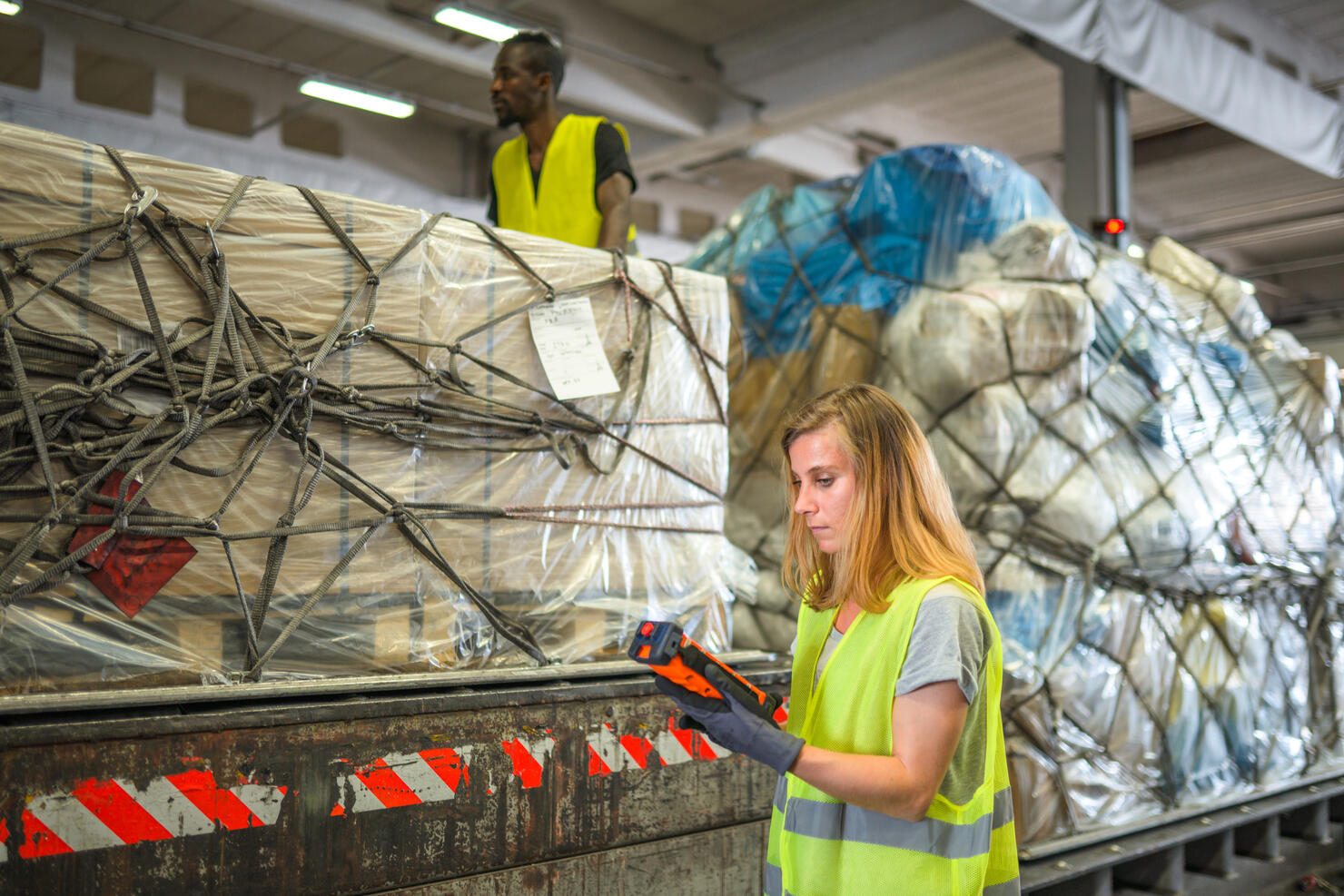 Diverse Airport Warehouse Coworkers Moving Cargo