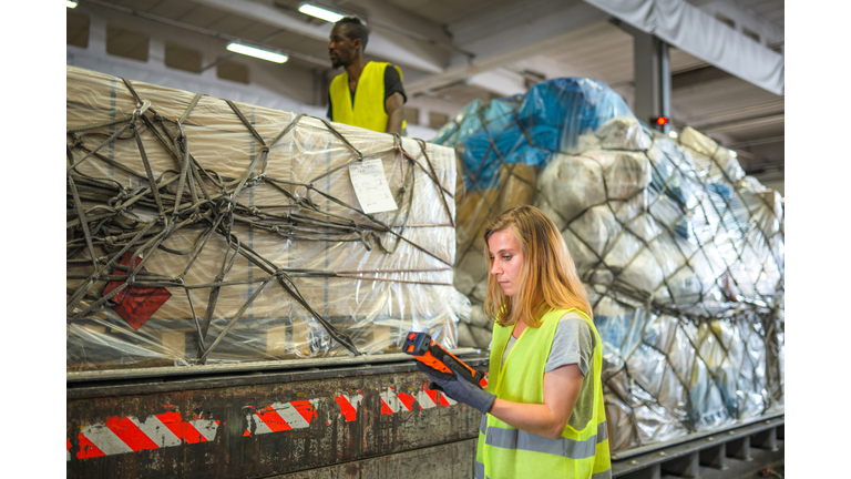 Diverse Airport Warehouse Coworkers Moving Cargo