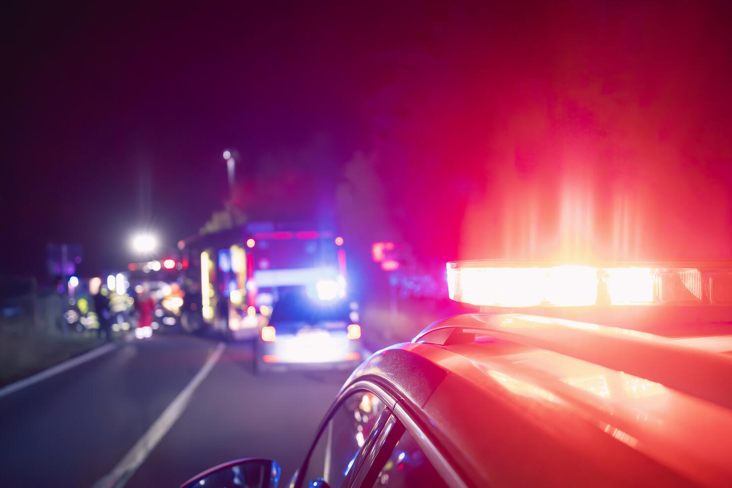 Red flashing light on ambulance car while responding at traffic accident at night