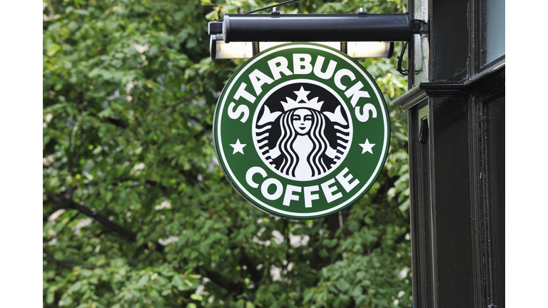 Starbucks coffee sign hanging outside a shop