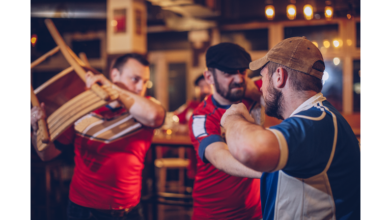 Men arguing in sports bar