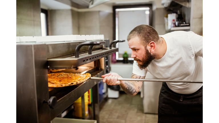 Pizza chef working in the kitchen