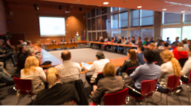 Public speaker giving talk at business event.