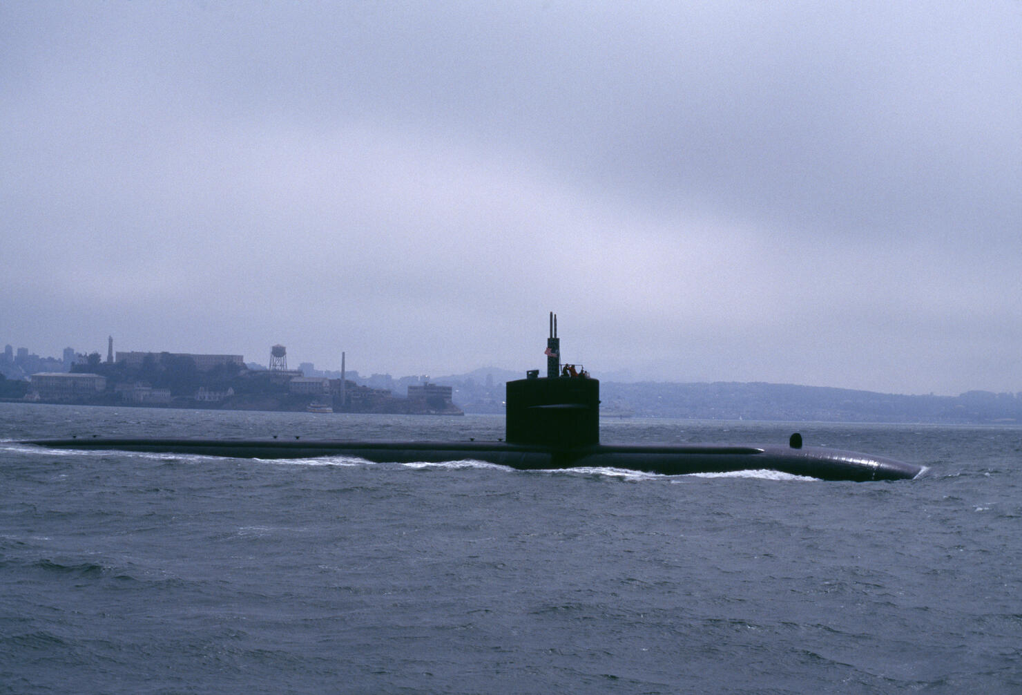 submarine slipping out to sea under fog San Francisco Bay